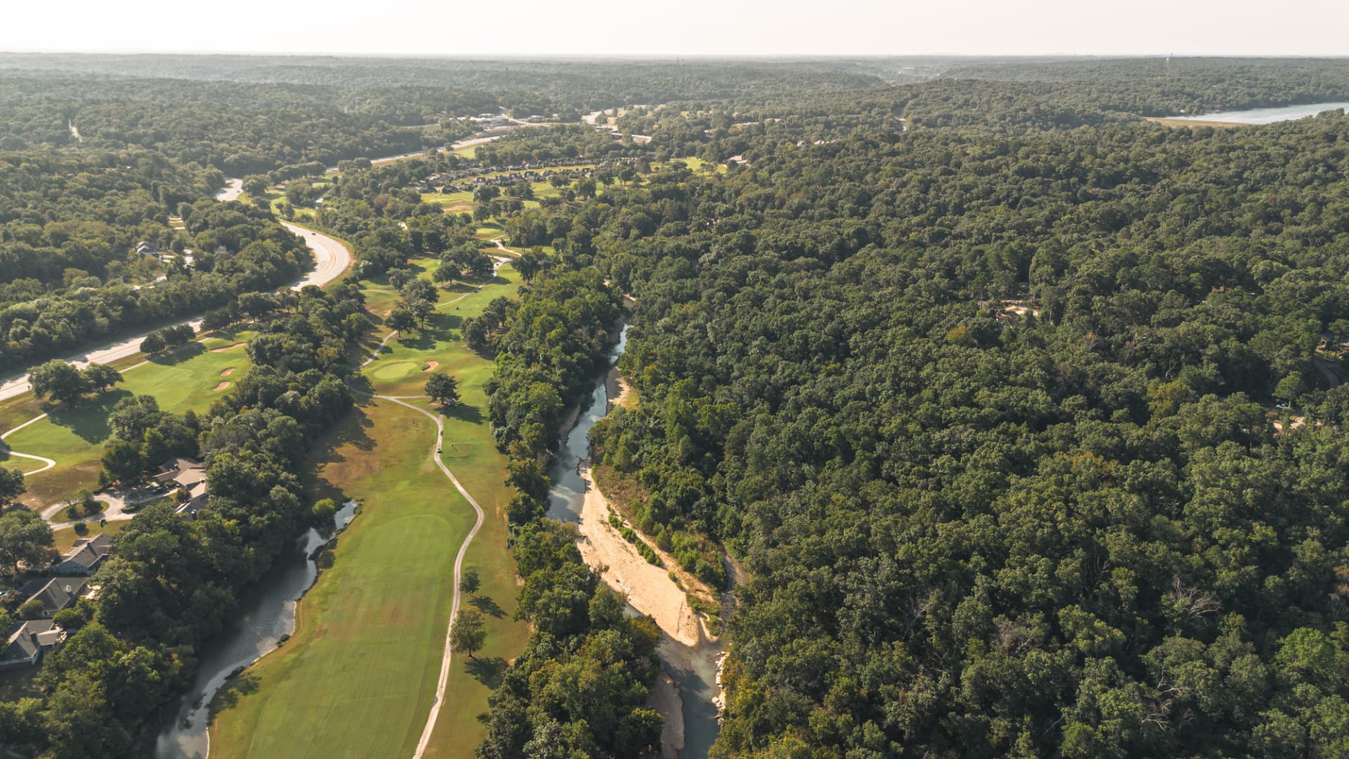 Aerial view of a golf course fairway along an Ozark river