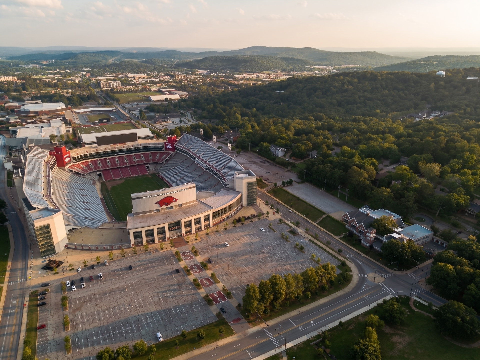 Daytime aerial of Razorback Stadium and the Ozark hills